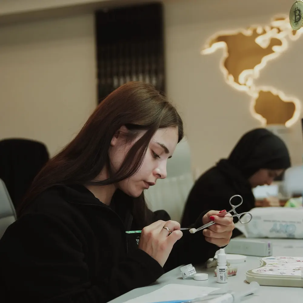 Technicians finishing crowns at a partner clinic lab